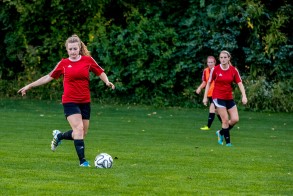 Women's soccer team player with the ball.